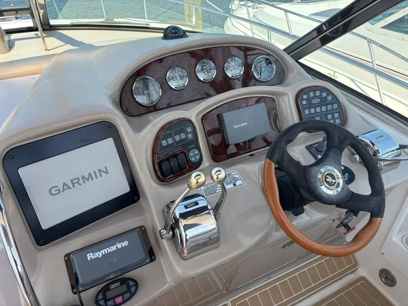 Slide: The Image of Helm of 2004 Sea Ray 320 Sundancer with Garmin and Raymarine navigation systems. - 17