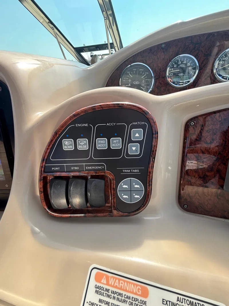 Slide: The Image of Control panel of a 2004 Sea Ray 320 Sundancer boat with various switches and gauges. - 18