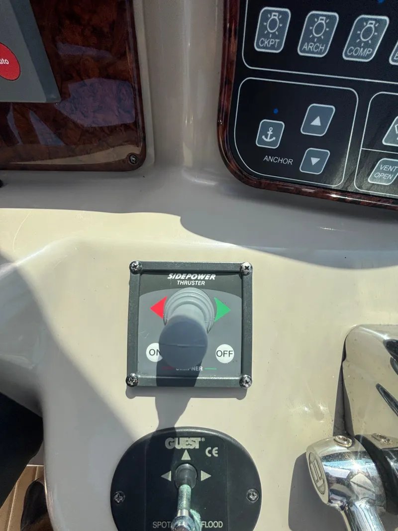 Slide: The Image of Control panel of a 2004 Sea Ray 320 Sundancer boat with thruster and anchor controls. - 21