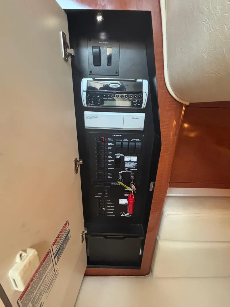 Slide: The Image of Electrical panel inside a 2004 Sea Ray 320 Sundancer boat cabin. - 22