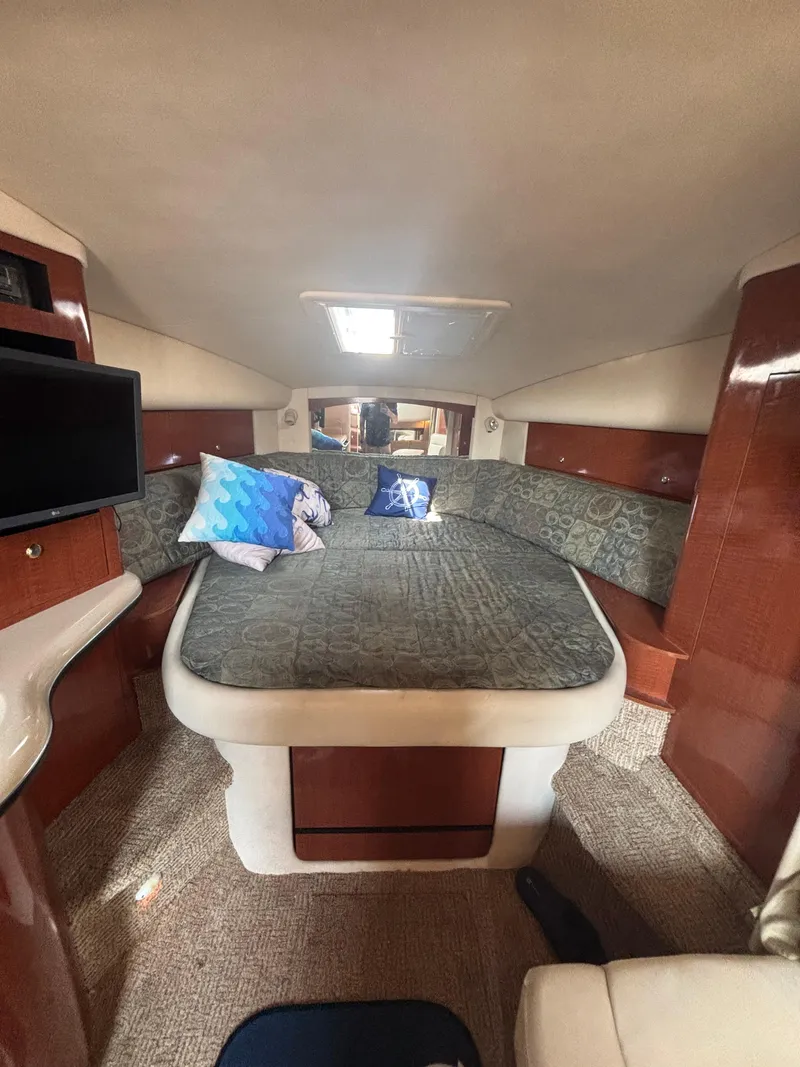 Slide: The Image of Interior of 2004 Sea Ray 320 Sundancer with cozy bed and modern amenities. - 29
