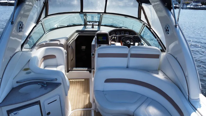 Slide: The Image of 2004 Sea Ray 320 Sundancer boat interior with helm, seating, and water view. - 39