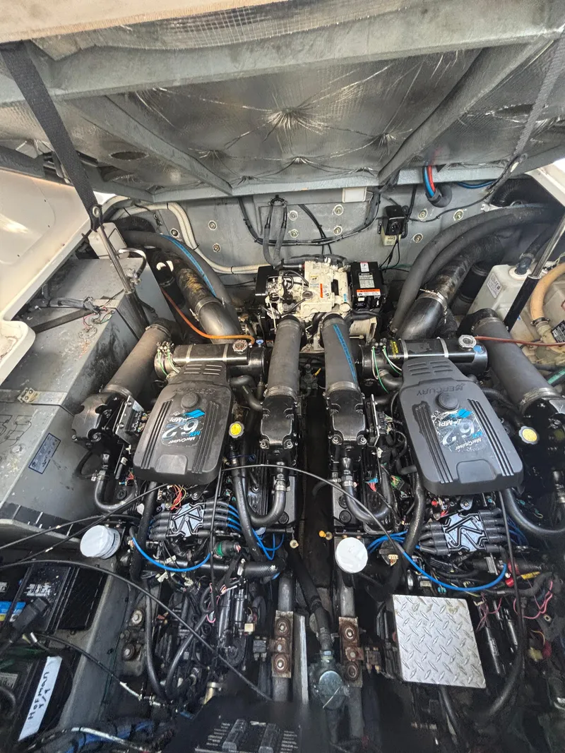 Slide: The Image of Engine compartment of a 2004 Sea Ray 320 Sundancer boat, showcasing dual engines. - 46