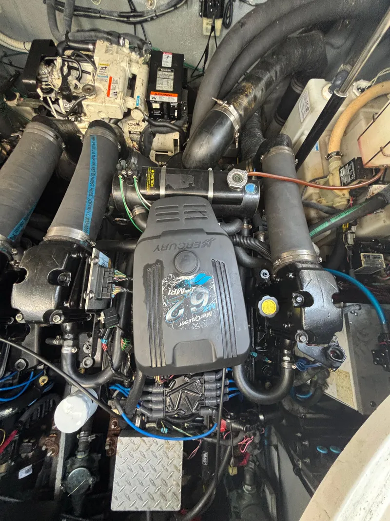 Slide: The Image of Engine compartment of a 2004 Sea Ray 320 Sundancer with Mercury components. - 47