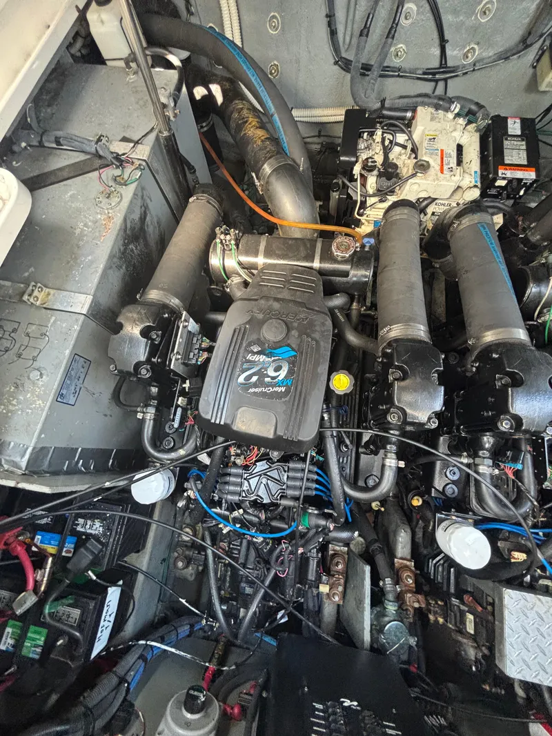 Slide: The Image of Engine compartment of a 2004 Sea Ray 320 Sundancer boat, showcasing mechanical components. - 48