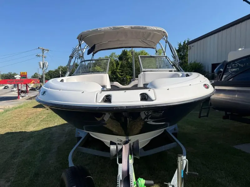 Slide: The Image of 2007 Yamaha Boats SX210 on trailer, parked outdoors under clear blue sky. - 2
