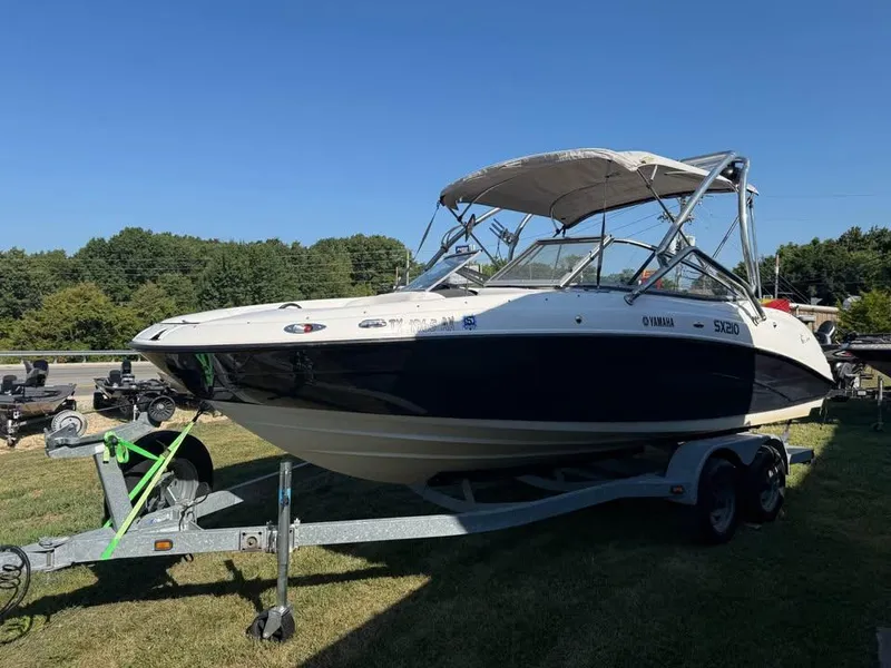 Slide: The Image of 2007 Yamaha SX210 boat on trailer, parked on grass under clear blue sky. - 3