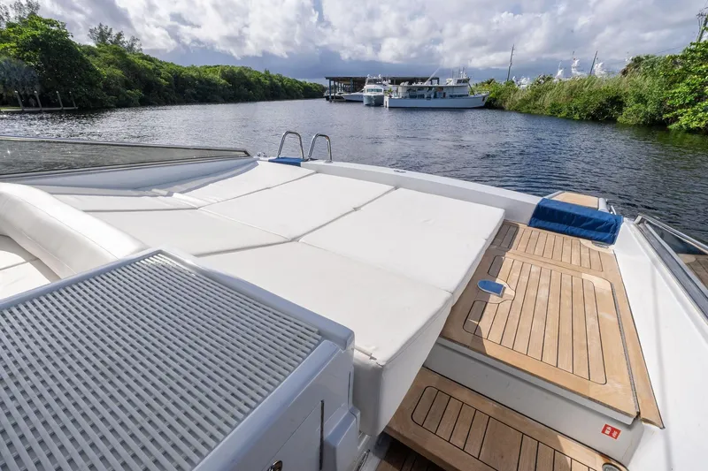 Slide: The Image of 1995 Itama 46 yacht with spacious deck, moored on a serene river. - 12