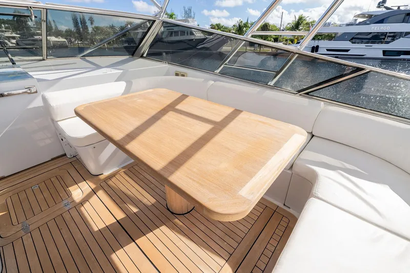 Slide: The Image of Luxurious Itama 46 yacht interior with wooden table and white seating, 1995 model. - 14
