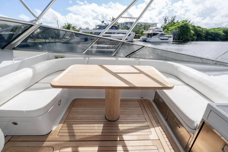 Slide: The Image of Luxurious seating area on a 1995 Itama 46 yacht with wooden table and scenic water view. - 15