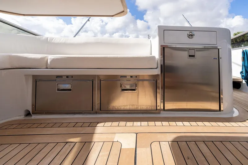 Slide: The Image of Luxury Itama 46 yacht deck with stainless steel storage, 1995 model, featuring teak flooring. - 16