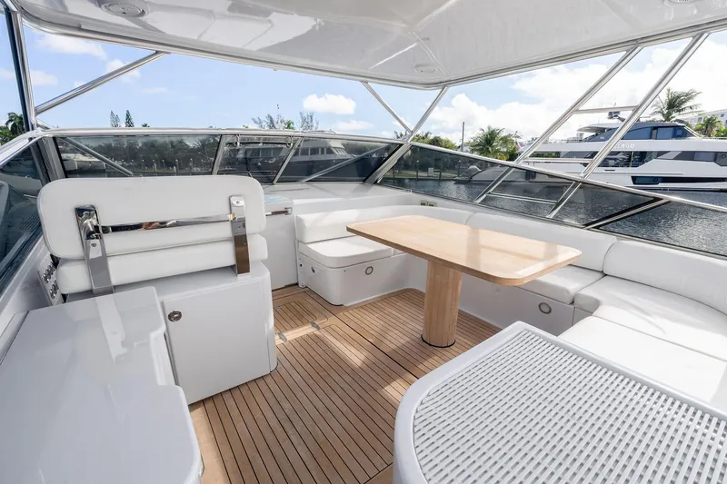 Slide: The Image of Luxurious interior of a 1995 Itama 46 yacht with white seating and wooden table. - 22
