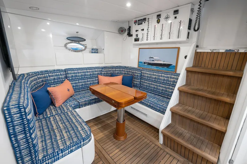 Slide: The Image of Luxurious interior of a 1995 Itama 46 yacht with blue seating and wooden flooring. - 23