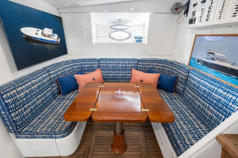 Slide: The Image of Luxurious interior of a 1995 Itama 46 yacht with blue patterned seating and wooden table. - 24