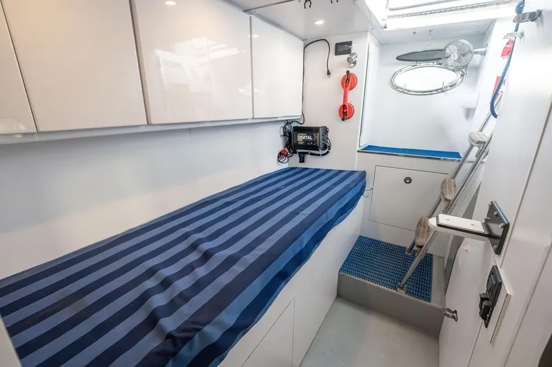 Slide: The Image of Interior cabin of a 1995 Itama 46 yacht with striped bedding and modern amenities. - 34