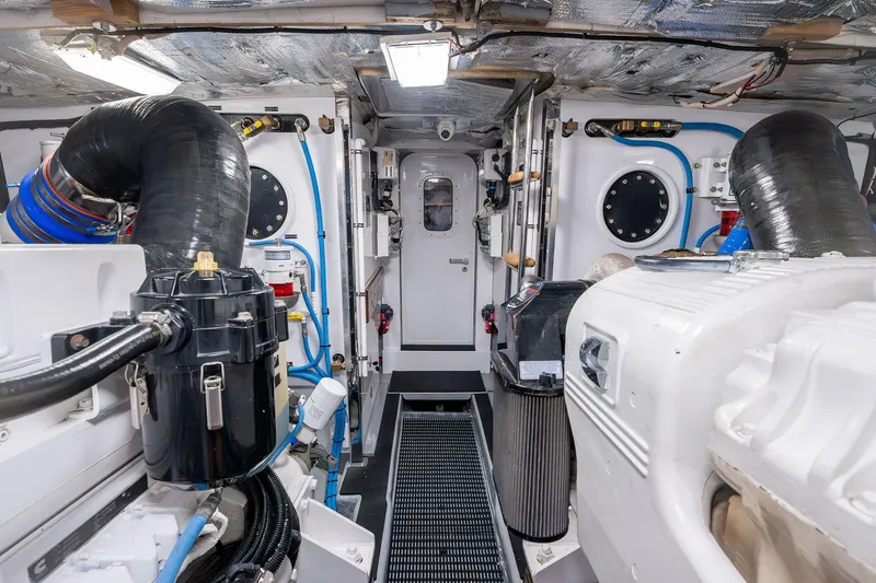 Slide: The Image of Engine room of a 1995 Itama 46 yacht, featuring mechanical components and piping. - 36