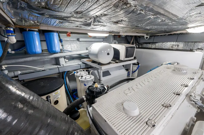 Slide: The Image of Engine room of a 1995 Itama 46 yacht, featuring mechanical equipment and components. - 38