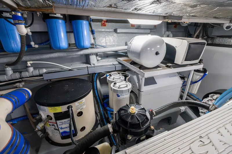 Slide: The Image of Engine room of a 1995 Itama 46 yacht, featuring filtration and mechanical systems. - 39