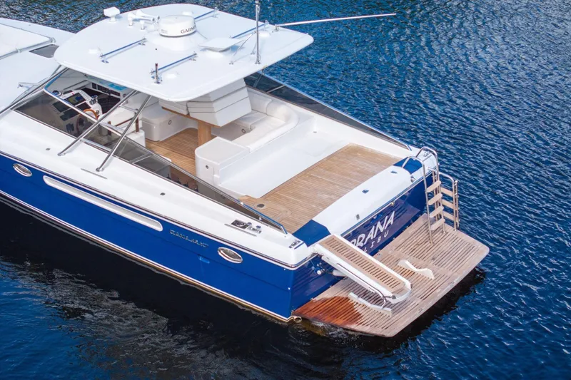 Slide: The Image of 1995 Itama 46 yacht with blue hull, spacious deck, and modern amenities on water. - 4
