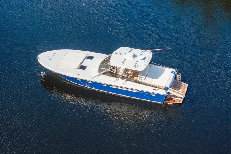 Slide: The Image of Aerial view of a 1995 Itama 46 yacht cruising on calm blue waters. - 5