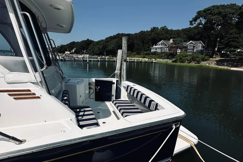 Slide: The Image of 2007 Sabreline 34 Express yacht docked by scenic waterfront homes. - 13