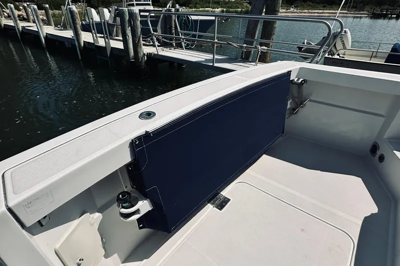 Slide: The Image of 2007 Sabreline 34 Express boat interior with blue seating and dock view. - 17