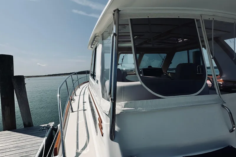 Slide: The Image of 2007 Sabreline 34 Express boat docked by the water on a sunny day. - 19