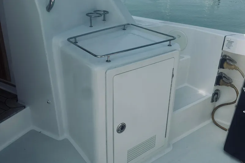 Slide: The Image of 2007 Sabreline 34 Express boat deck with storage compartment and power connections. - 23