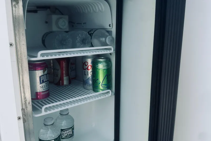 Slide: The Image of Mini fridge stocked with drinks on a 2007 Sabreline 34 Express boat. - 24