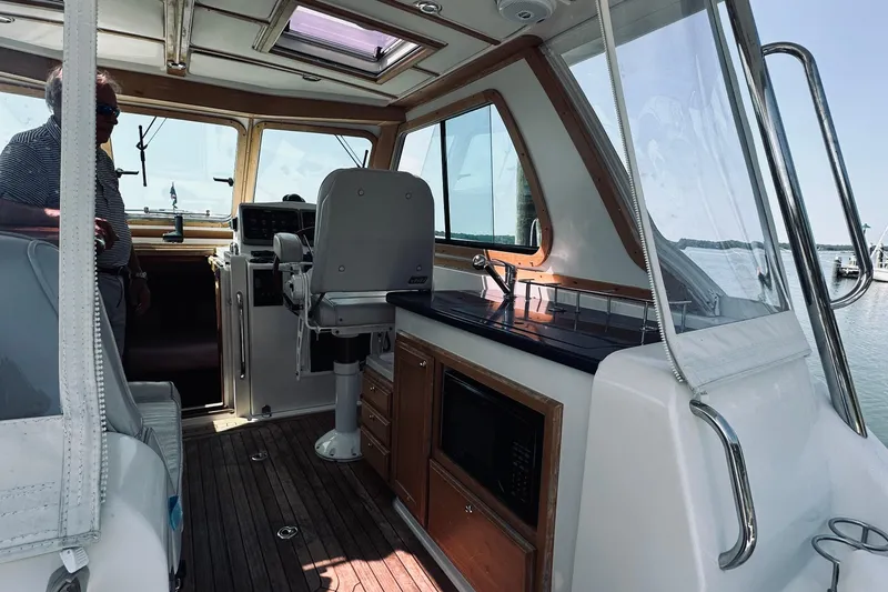 Slide: The Image of 2007 Sabreline 34 Express boat interior with helm, seating, and kitchenette. - 25