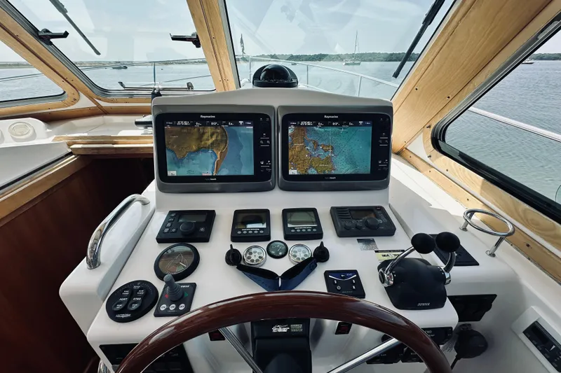 Slide: The Image of 2007 Sabreline 34 Express helm with navigation screens and controls on a sunny day. - 31
