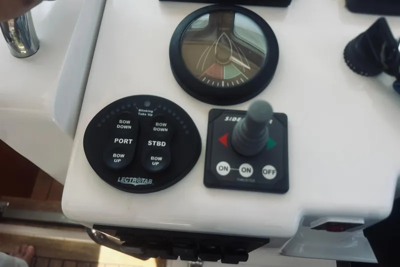 Slide: The Image of Control panel of a 2007 Sabreline 34 Express boat with trim and thruster controls. - 38
