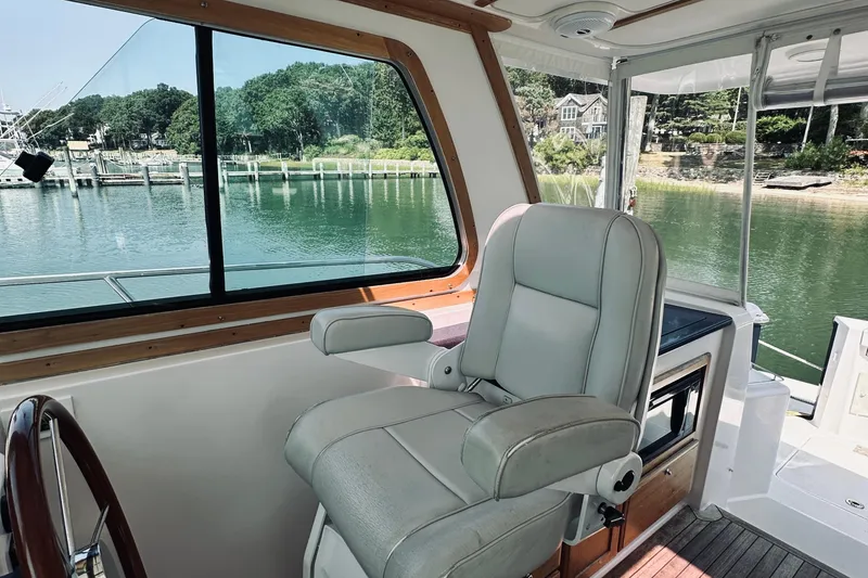 Slide: The Image of Interior of 2007 Sabreline 34 Express boat with helm seat and scenic water view. - 41