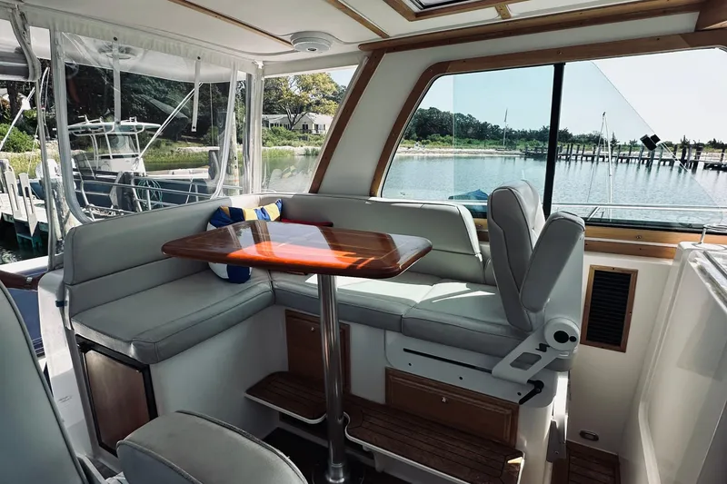 Slide: The Image of Interior of 2007 Sabreline 34 Express yacht with seating and table, overlooking marina. - 43