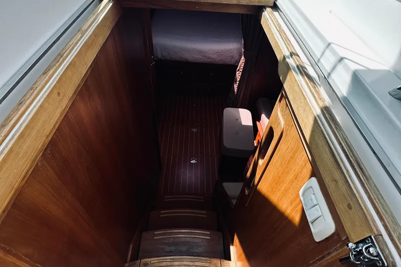 Slide: The Image of Interior view of 2007 Sabreline 34 Express boat, featuring wooden stairs and cabin entrance. - 45