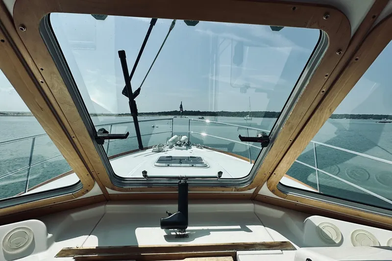 Slide: The Image of 2007 Sabreline 34 Express boat interior view through windshield on calm water. - 46