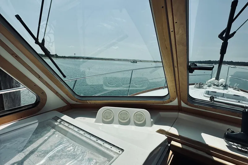 Slide: The Image of Interior view from 2007 Sabreline 34 Express yacht, overlooking calm waters through large windows. - 48