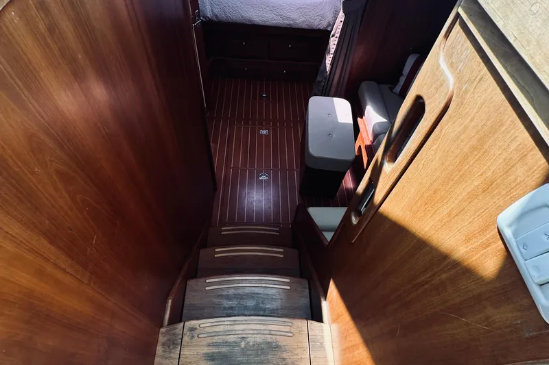 Slide: The Image of Interior view of 2007 Sabreline 34 Express, featuring wooden stairs and cabin area. - 49