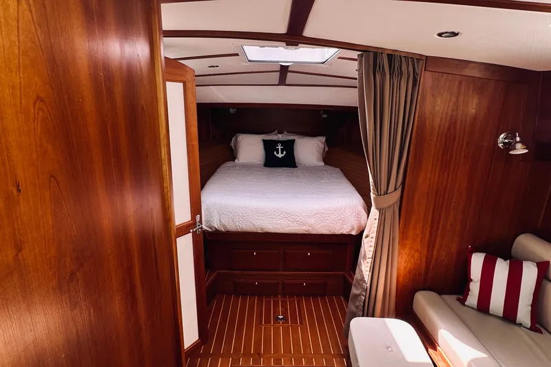 Slide: The Image of Luxurious 2007 Sabreline 34 Express cabin interior with wood finish and cozy bedding. - 51