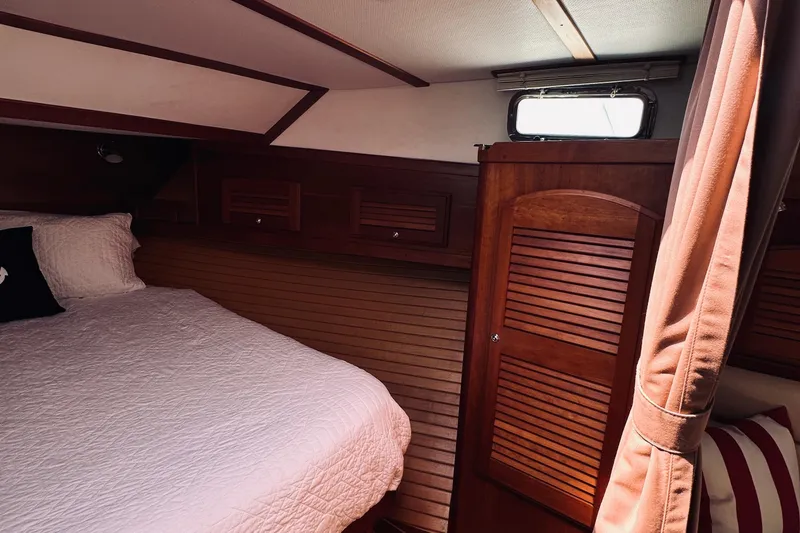 Slide: The Image of Cozy cabin interior of 2007 Sabreline 34 Express with wood paneling and bed. - 55