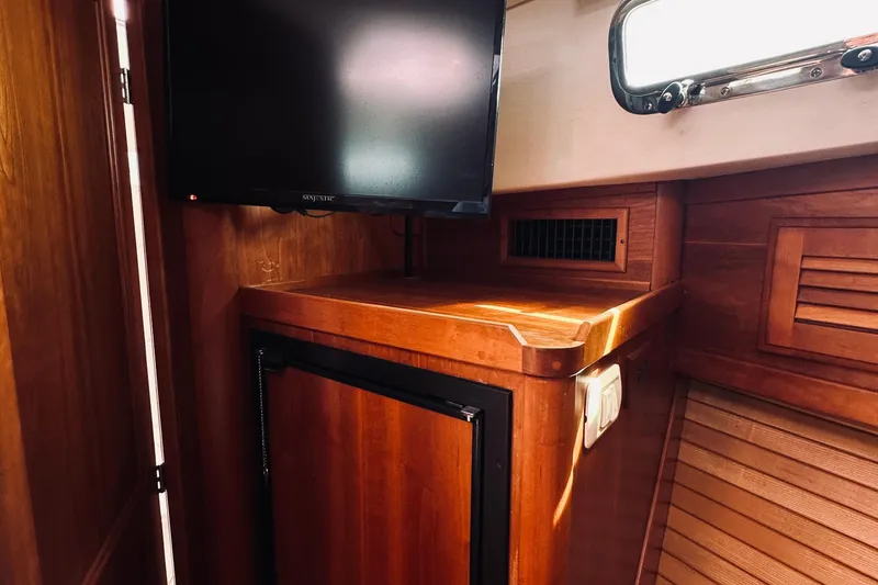 Slide: The Image of Interior of 2007 Sabreline 34 Express with wooden cabinetry and mounted TV. - 56