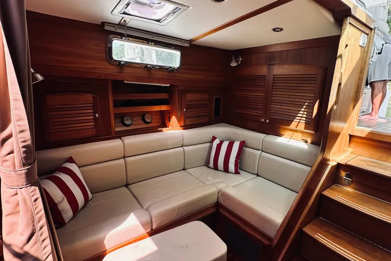 Slide: The Image of Interior of 2007 Sabreline 34 Express yacht with cozy seating and striped cushions. - 60
