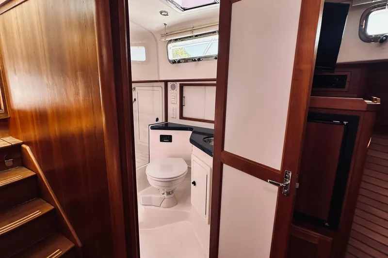 Slide: The Image of 2007 Sabreline 34 Express yacht interior with wooden finish and compact bathroom. - 62