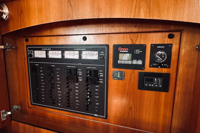 Slide: The Image of Electrical control panel on a 2007 Sabreline 34 Express boat, featuring gauges and switches. - 65