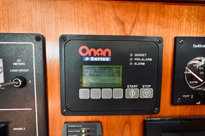 Slide: The Image of Onan e-Series control panel on 2007 Sabreline 34 Express boat dashboard. - 66