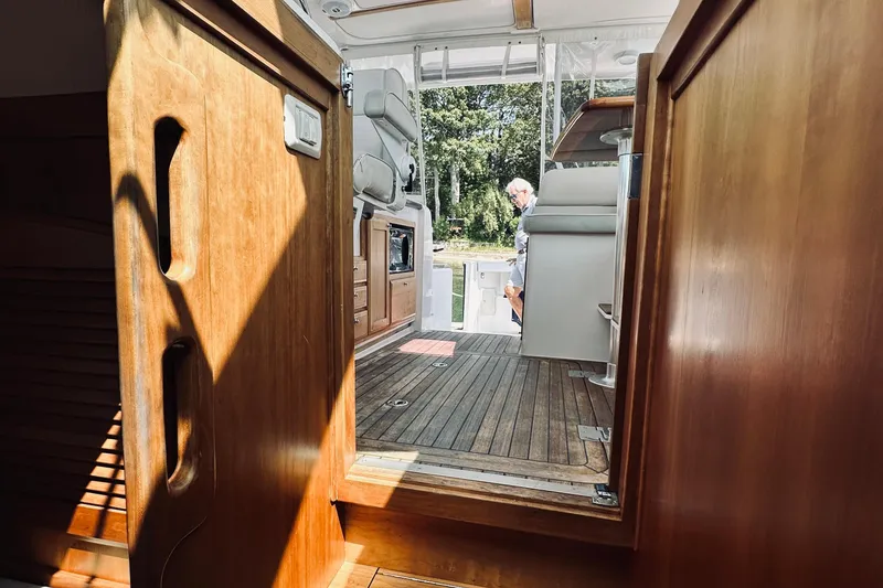 Slide: The Image of 2007 Sabreline 34 Express interior with wooden finish and open deck view. - 68