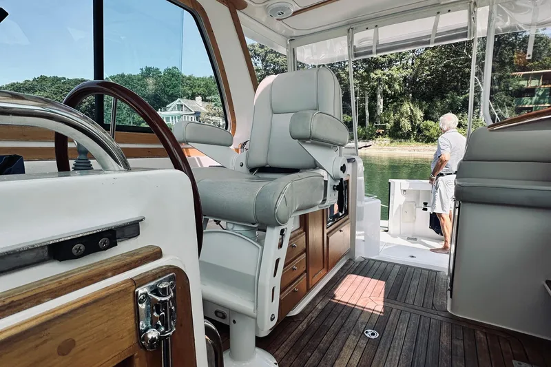 Slide: The Image of 2007 Sabreline 34 Express boat interior with helm, seating, and view of water. - 69