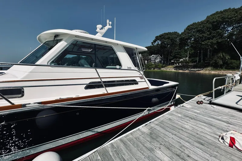 Slide: The Image of 2007 Sabreline 34 Express yacht docked at a serene marina. - 7