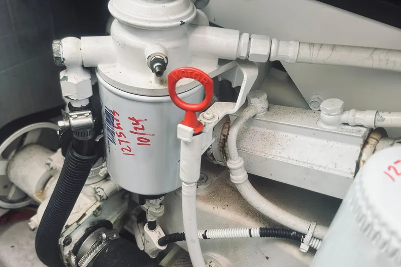 Slide: The Image of Engine components of a 2007 Sabreline 34 Express boat, featuring a filter and red dipstick. - 72