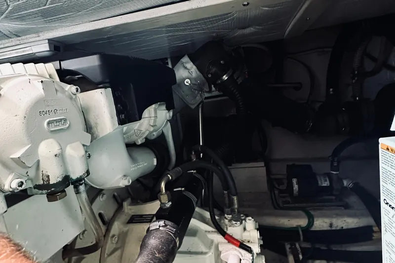 Slide: The Image of Engine compartment of a 2007 Sabreline 34 Express boat, showcasing mechanical components. - 75